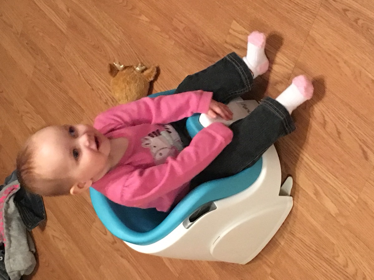 Young Sophia sitting in a supportive chair in 2016