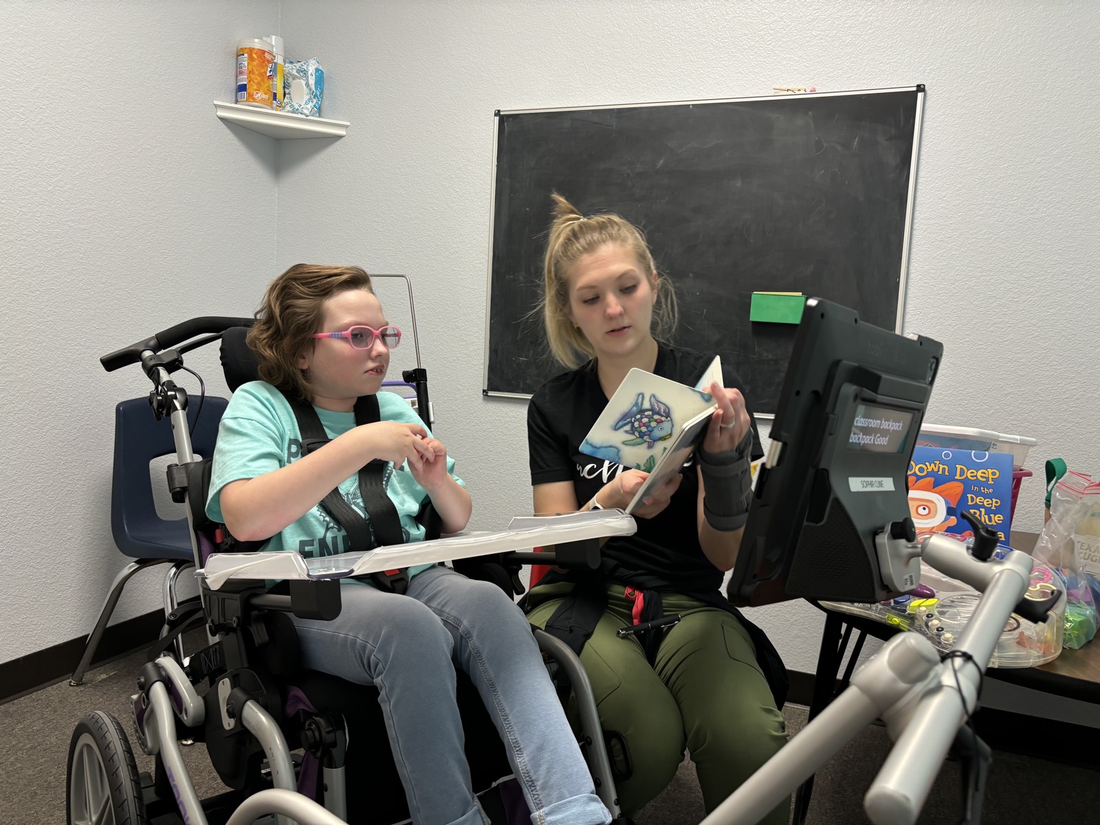 Sophia in speech therapy enjoying books being read to her