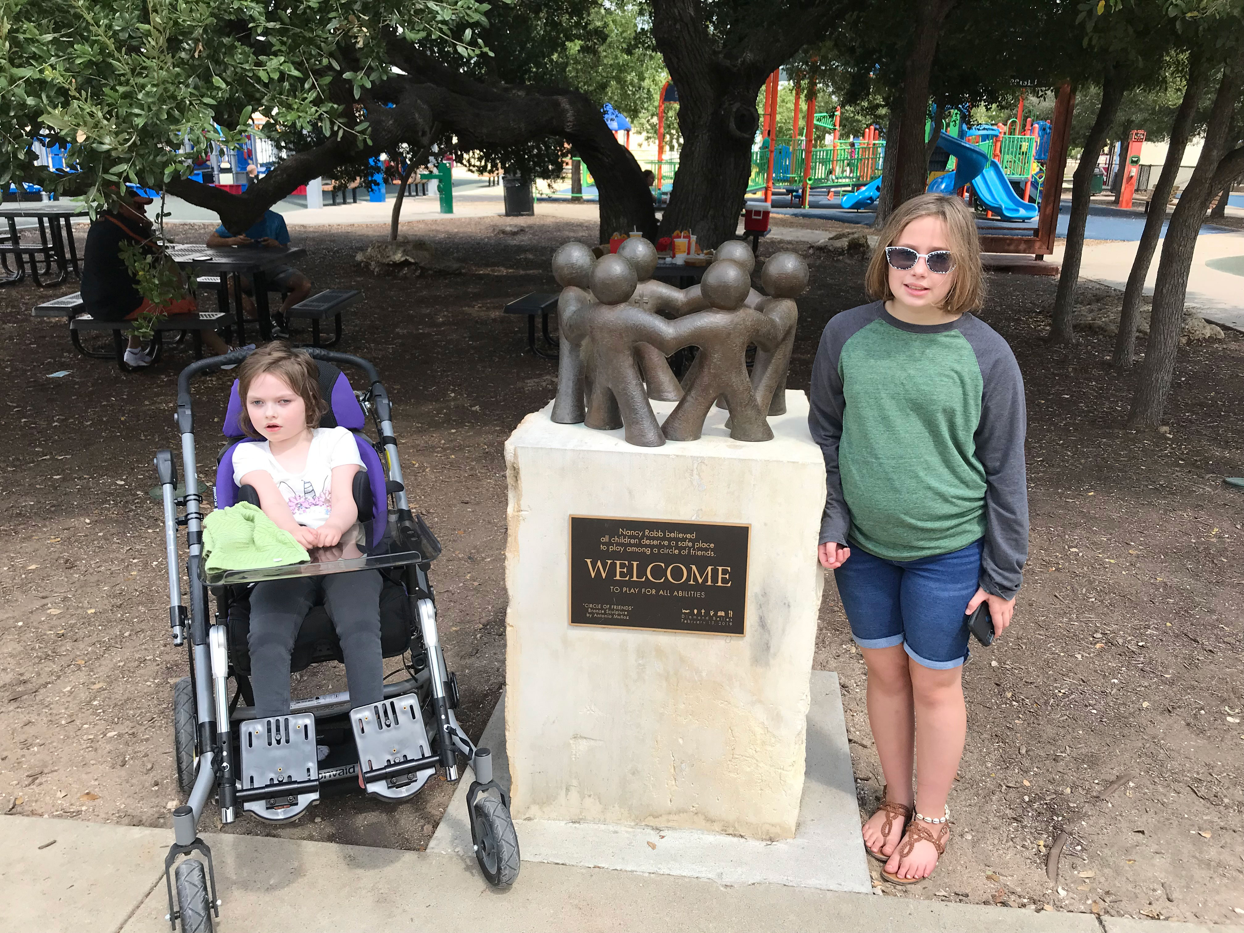 Sophia with her sister at a playground